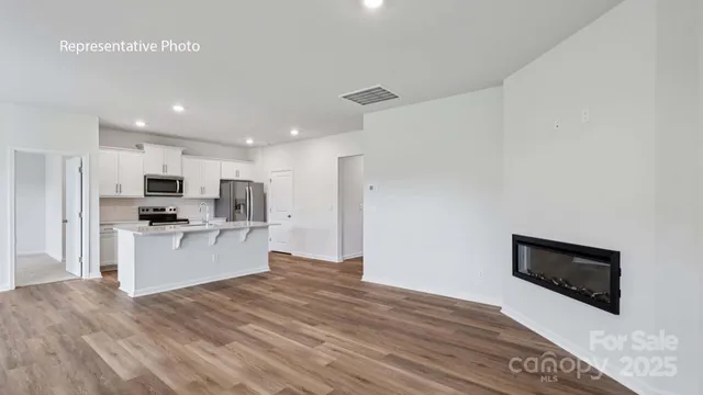 a kitchen with stainless steel appliances granite countertop a refrigerator and a stove top oven