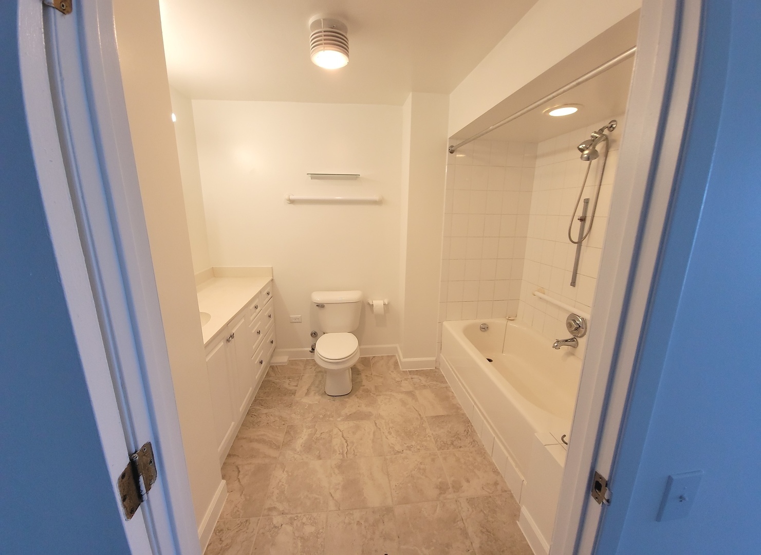 5415 North Sheridan Road, Unit 2805 Chicago, IL 60640 - Photo 11 of 23 a bathroom with a sink a toilet a tub and shower