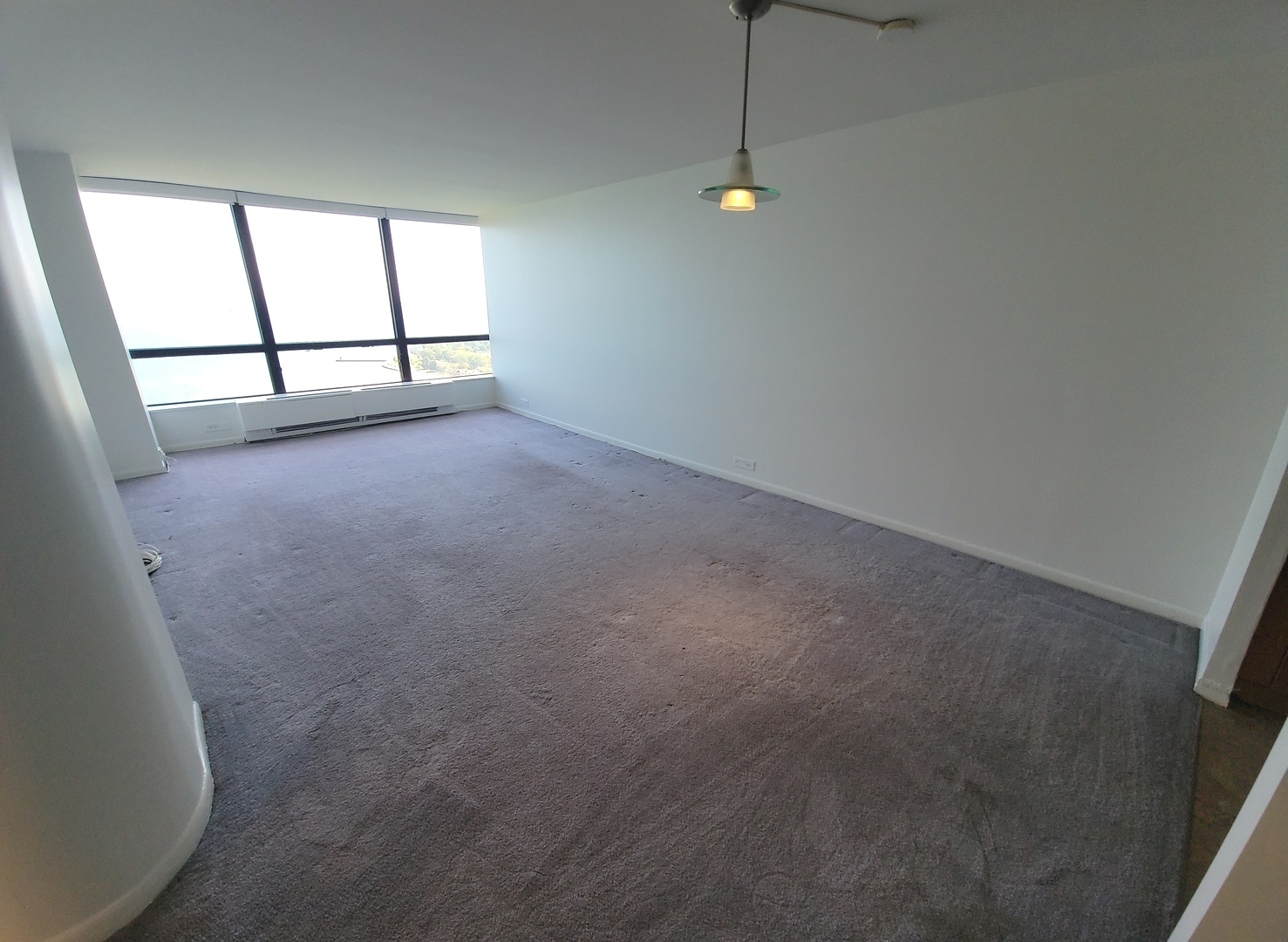 5415 North Sheridan Road, Unit 2805 Chicago, IL 60640 - Photo 4 of 23 en empty room with windows and ceiling fan