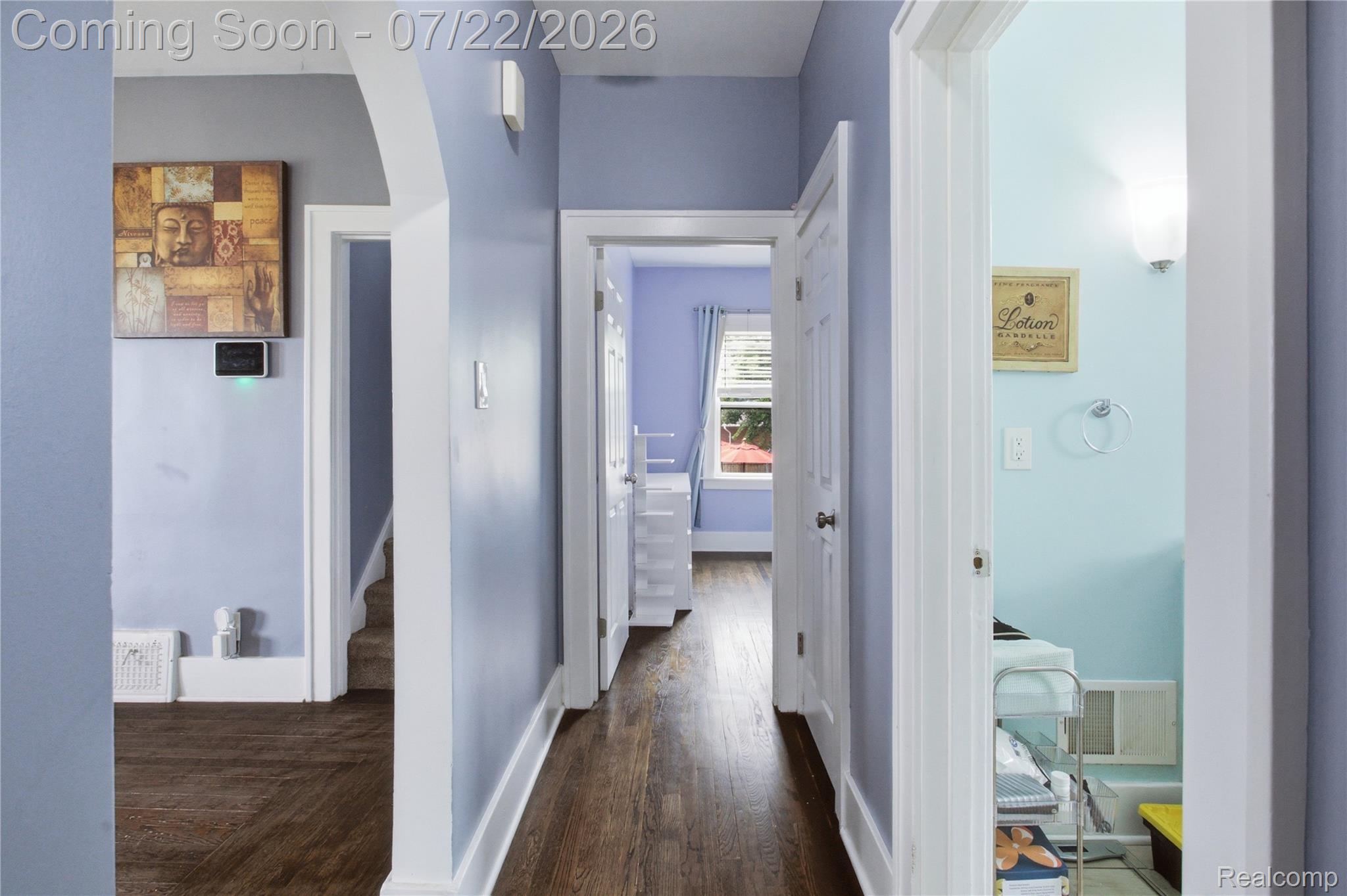 32127 Utica Road Fraser, MI 48026 - Photo 13 of 43 Hallway featuring wood-finish flooring, white baseboards, and light blue walls