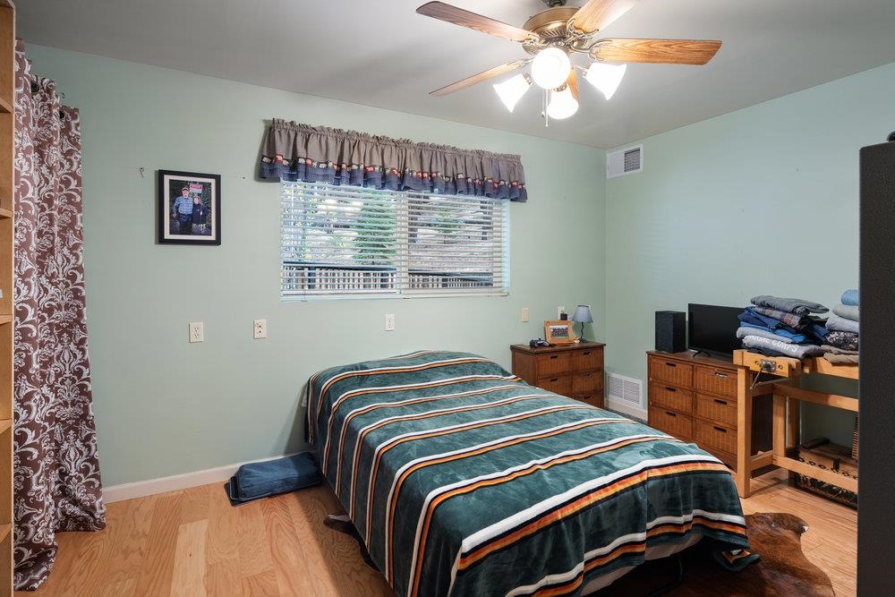 58882 Little Long Valley Creek Road Cromberg, CA 96103 - Photo 17 of 28 a bedroom with a bed and a chandelier