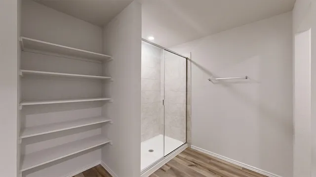 a bathroom with a glass shower door