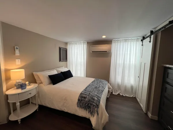 a bedroom with a bed and a window