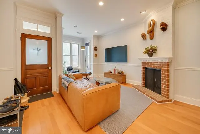 a living room with furniture a flat screen tv and a fireplace