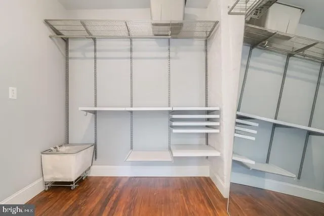 a view of a room with wooden floor and racks