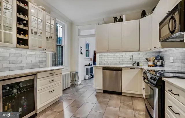 a kitchen with cabinets appliances and a counter
