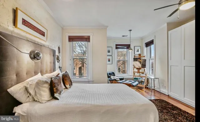 a bedroom with a bed and a large mirror