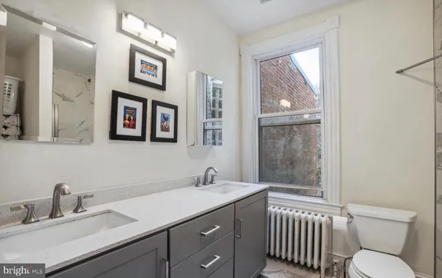 a bathroom with a toilet sink and mirror