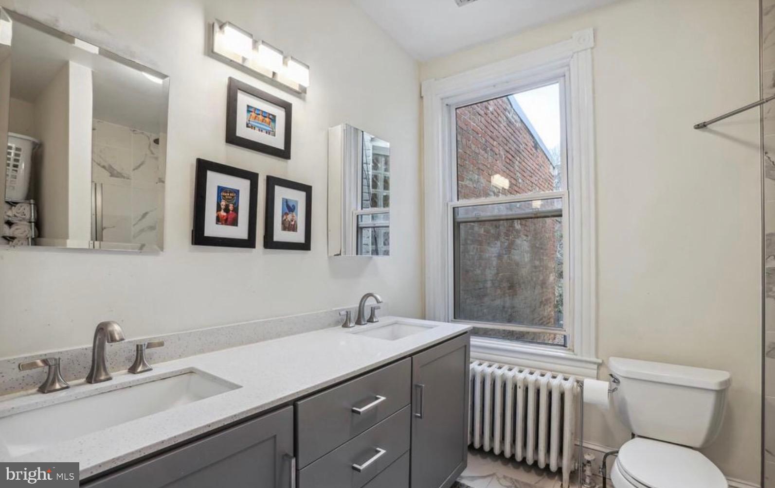 726 3rd Street Northeast Washington, DC 20002 - Photo 25 of 41 a bathroom with a toilet sink and mirror
