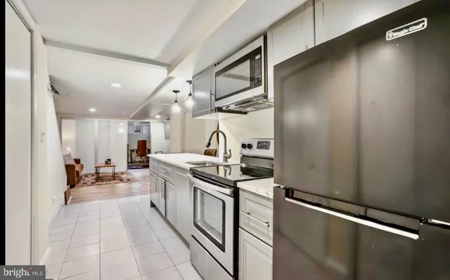 a kitchen with stainless steel appliances granite countertop a sink and cabinets