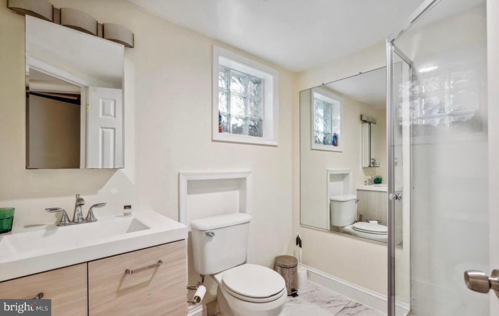 726 3rd Street Northeast Washington, DC 20002 - Photo 30 of 41 a bathroom with a sink a toilet and shower