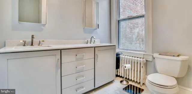 a bathroom with a sink toilet and mirror