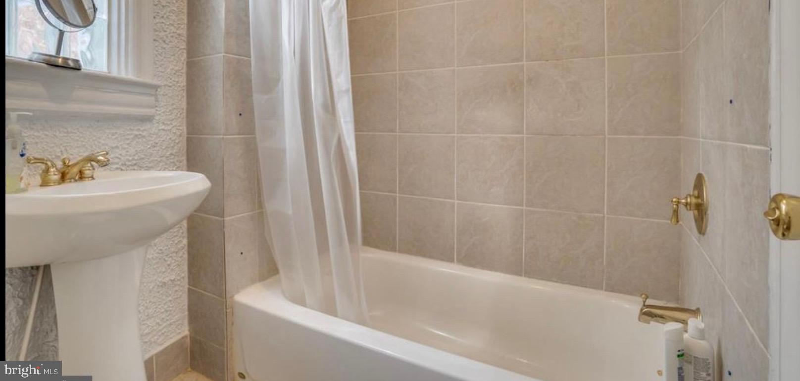 726 3rd Street Northeast Washington, DC 20002 - Photo 35 of 41 a bathroom with a sink a toilet and shower