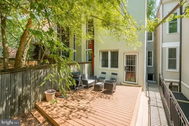 a view of a house with backyard sitting area and wooden floor