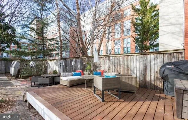 a backyard view of a house with barbeque oven and seating