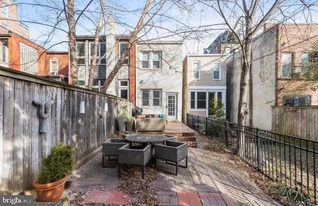 a view of a patio with couches table and chairs and potted plants
