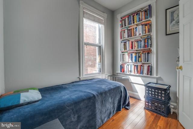726 3rd Street Northeast Washington, DC 20002 - Photo 8 of 41 a bedroom with a bed and a book shelf