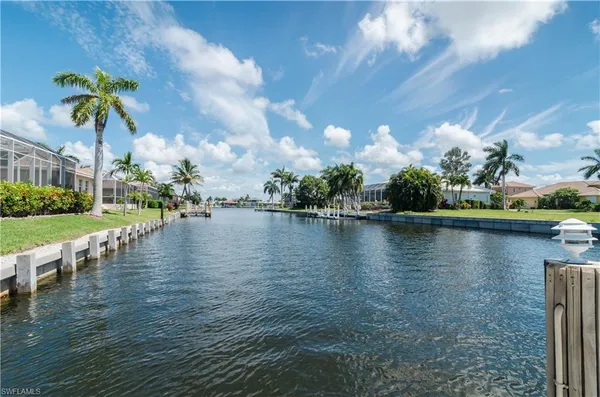 a view of a lake with houses in the back