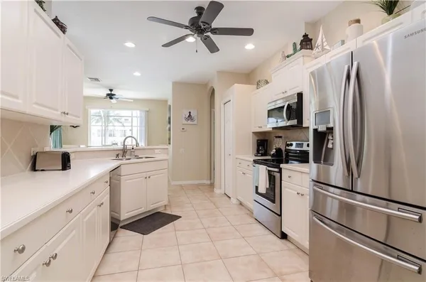 a kitchen with stainless steel appliances a refrigerator sink and microwave