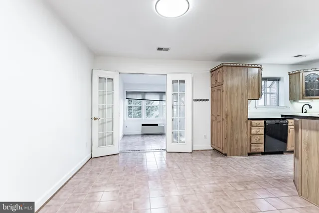 a view of a kitchen with refrigerator and a sink