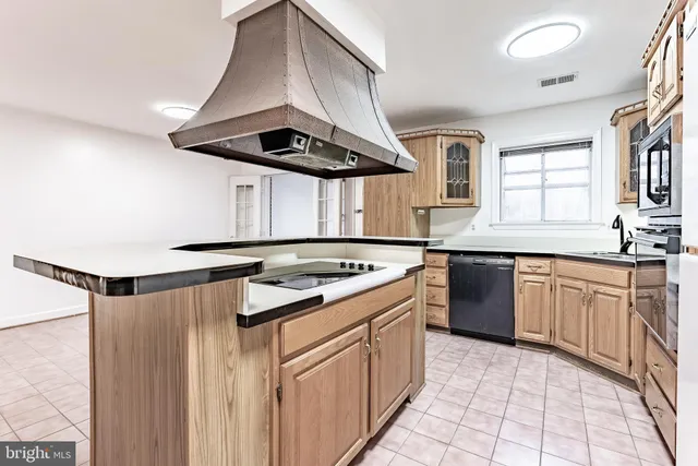 a kitchen with stainless steel appliances a stove a sink and a refrigerator