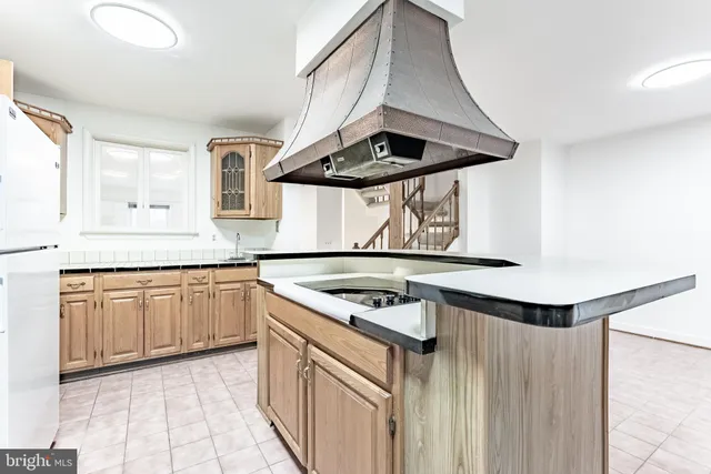 a kitchen with stainless steel appliances granite countertop a sink and a stove