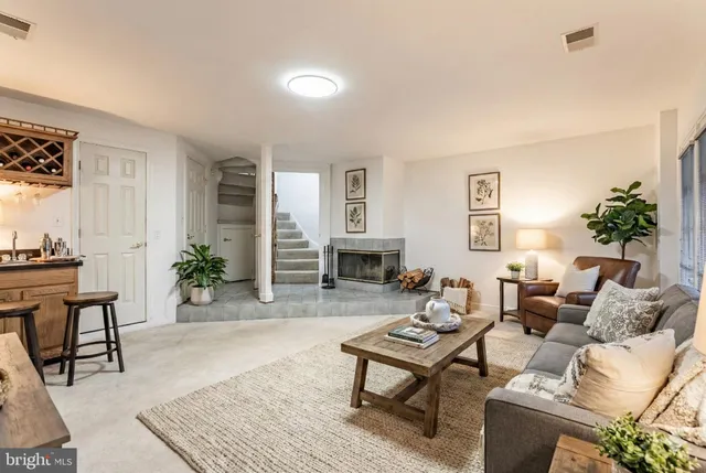 a living room with furniture a table and a potted plant