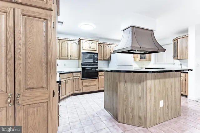a kitchen with stainless steel appliances a stove and more cabinets
