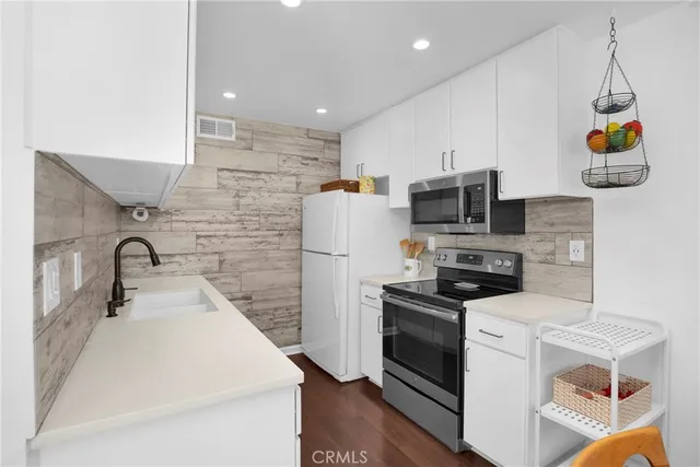 a kitchen with a sink a stove and refrigerator