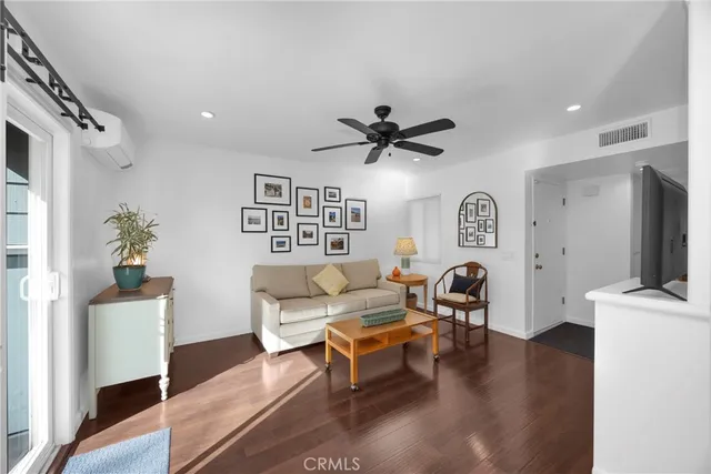 a living room with furniture a window and a flat screen tv