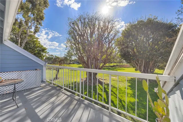 a view of balcony with wooden floor and fence