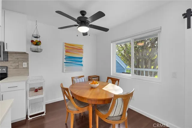 a dining room with furniture a window and wooden floor