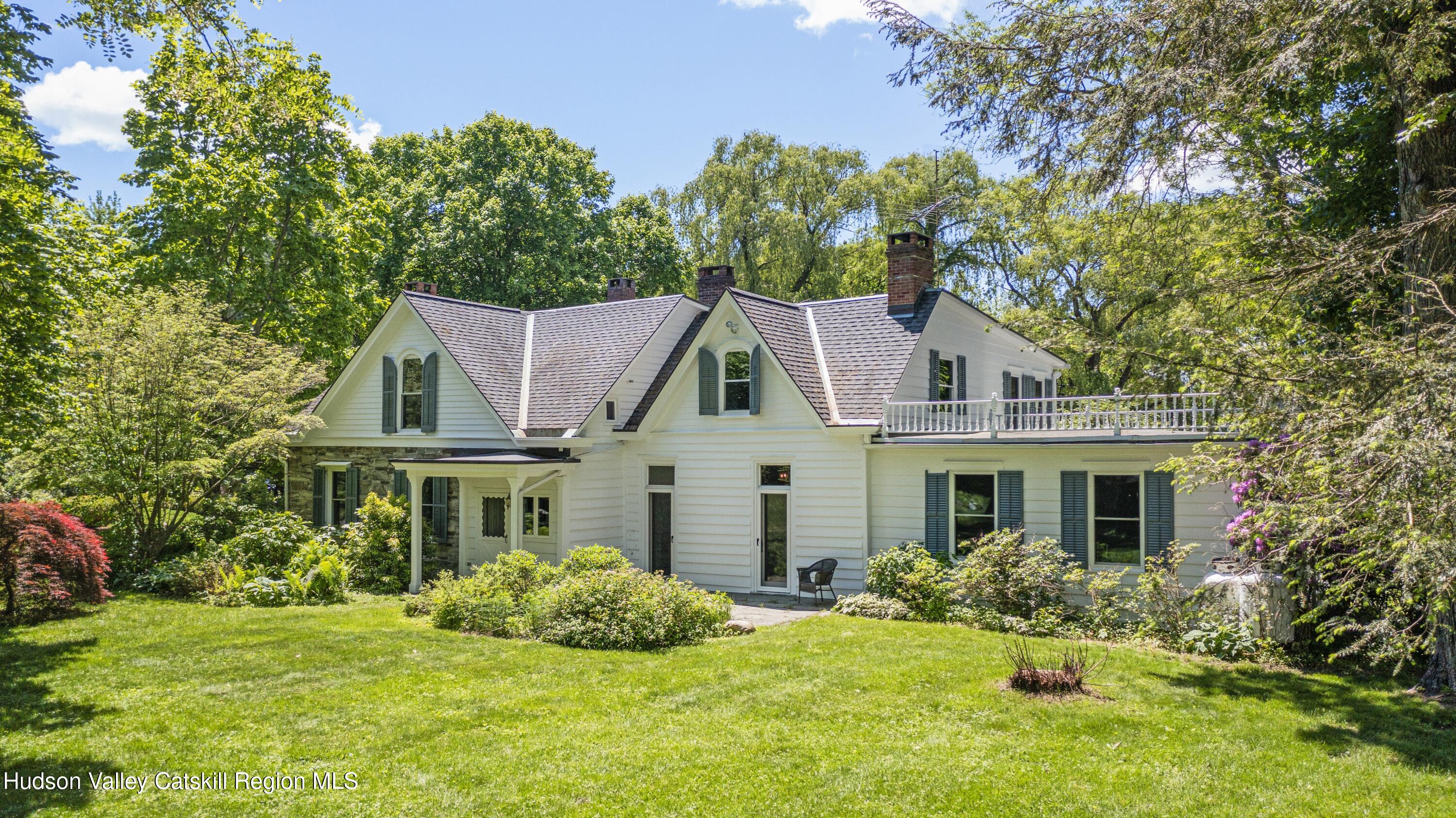 a front view of a house with a yard and porch
