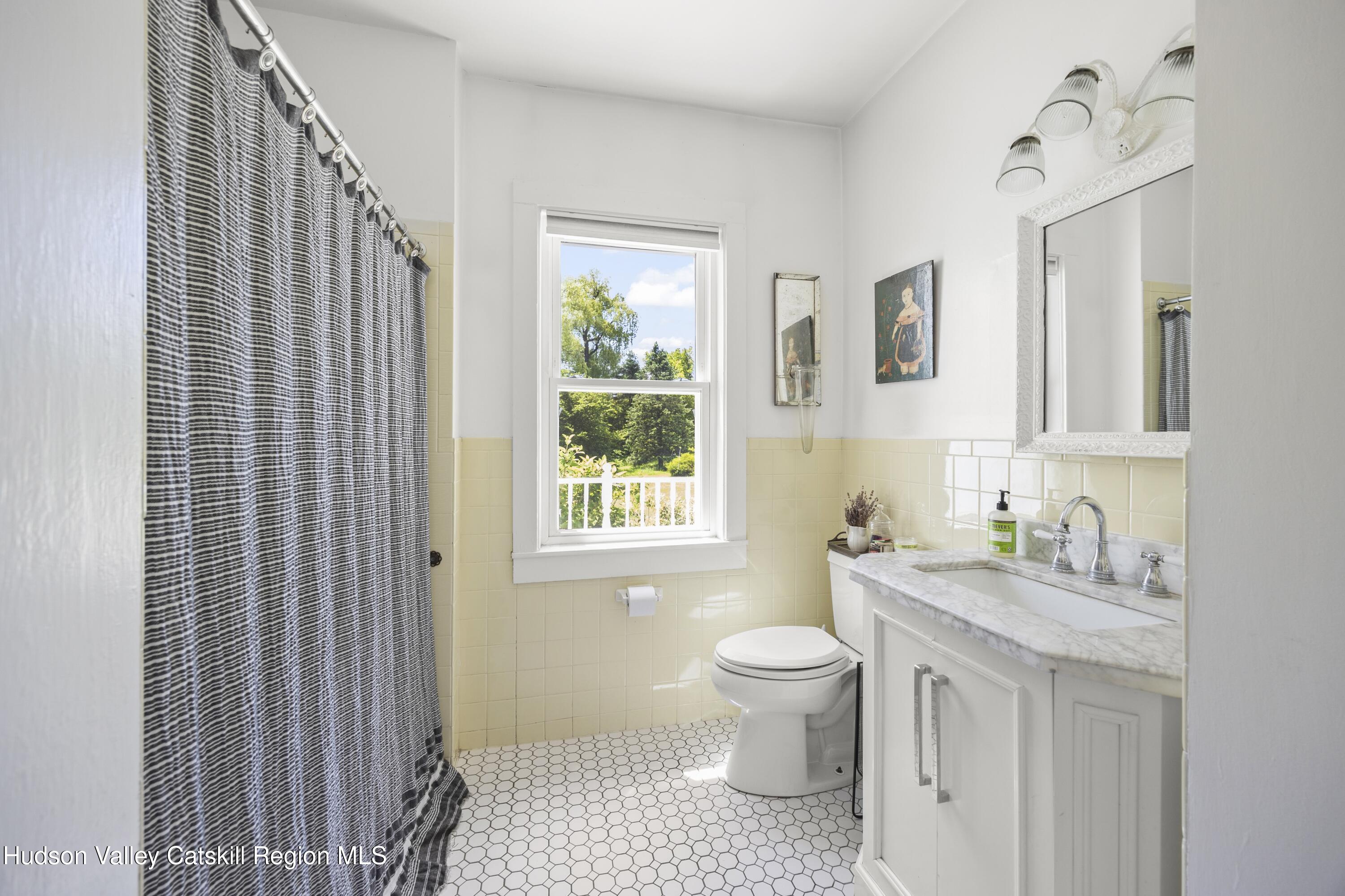 202 Buckwheat Bridge Road Germantown, NY 12526 - Photo 20 of 47 a bathroom with a sink toilet a mirror and shower
