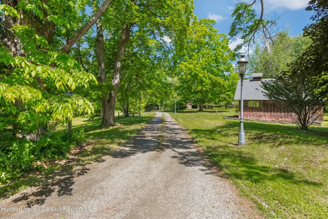 a dining room with furniture a rug a fireplace and a chandelier