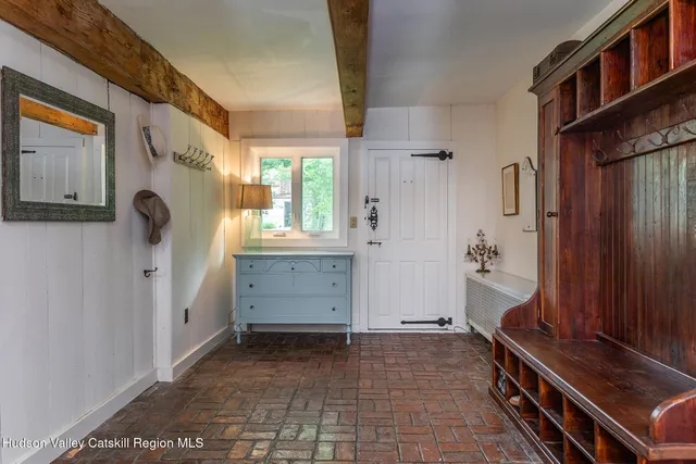 a view of a livingroom with furniture window and wooden floor