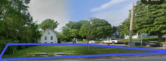 a view of yard with swimming pool and trees in the background