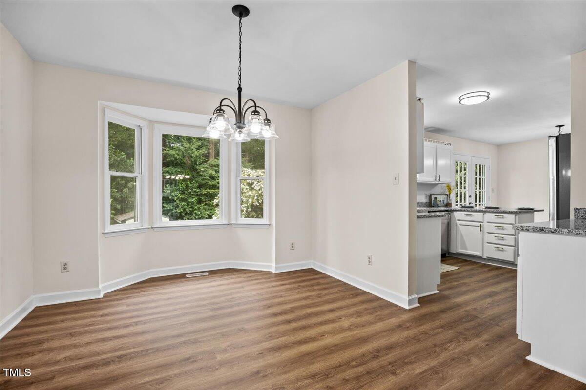 4309 Birmingham Way Raleigh, NC 27604 - Photo 19 of 60 a view of a kitchen with wooden floor and a window