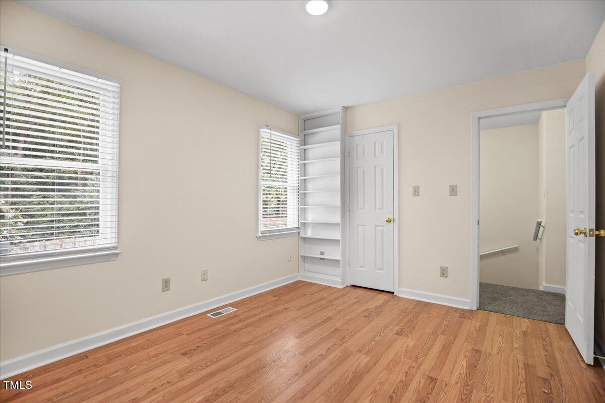 4309 Birmingham Way Raleigh, NC 27604 - Photo 22 of 60 a view of empty room with wooden floor and fan