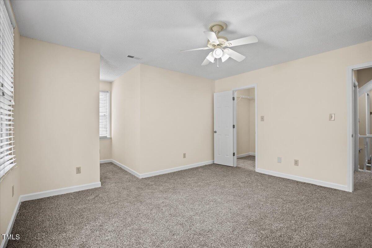 4309 Birmingham Way Raleigh, NC 27604 - Photo 28 of 60 a view of an empty room with a chandelier fan