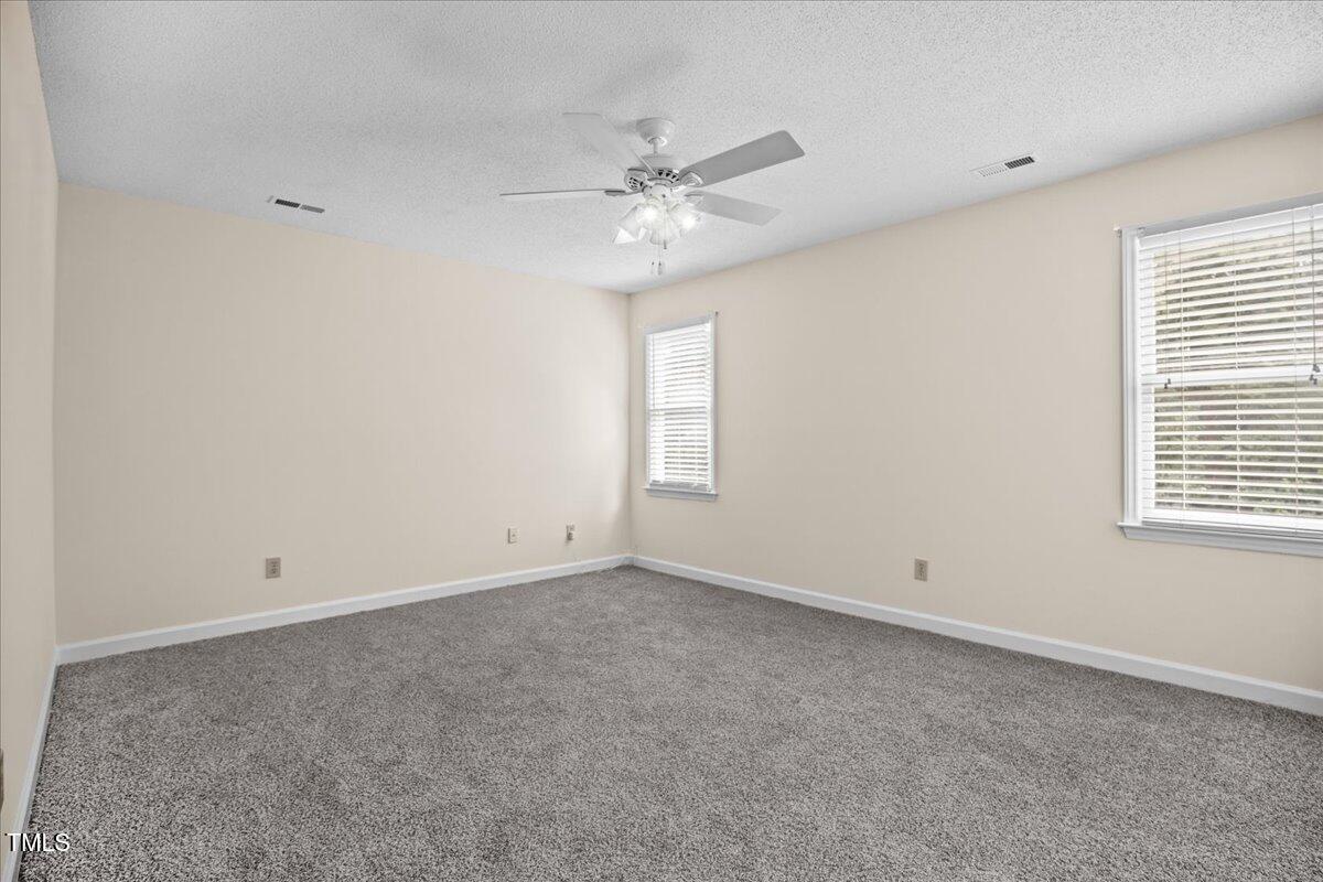 4309 Birmingham Way Raleigh, NC 27604 - Photo 30 of 60 an empty room with a window and a fan