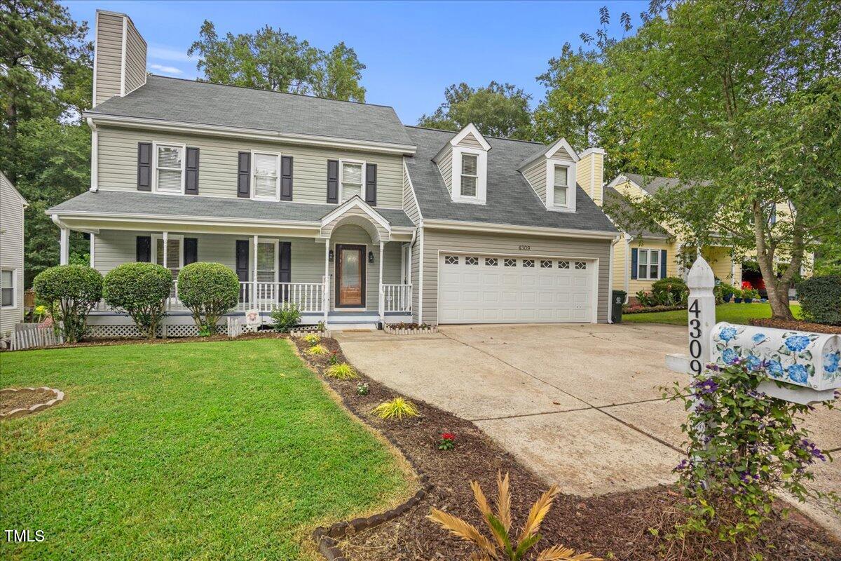 4309 Birmingham Way Raleigh, NC 27604 - Photo 3 of 60 a front view of a house with a yard and garage