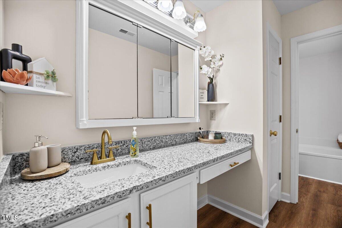 4309 Birmingham Way Raleigh, NC 27604 - Photo 35 of 60 a bathroom with a granite countertop sink and a mirror