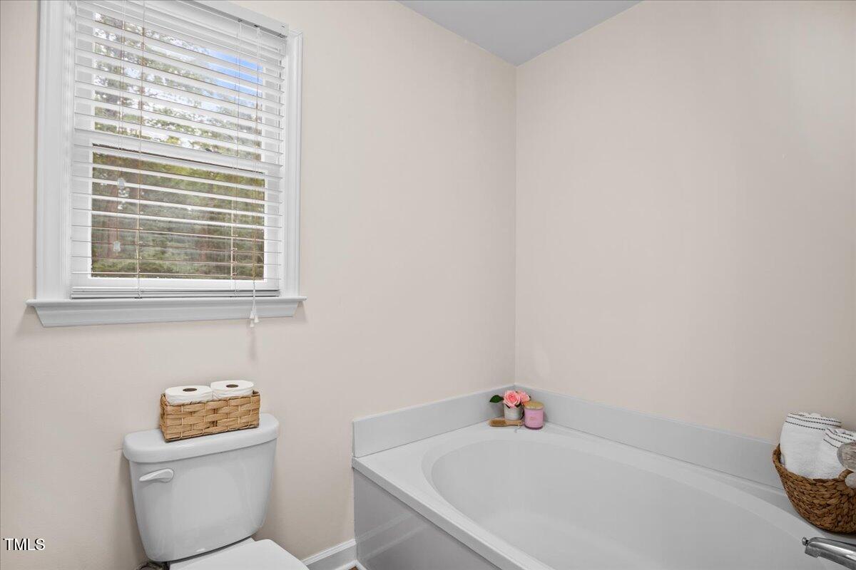 4309 Birmingham Way Raleigh, NC 27604 - Photo 36 of 60 a bathroom with a toilet a sink and a window