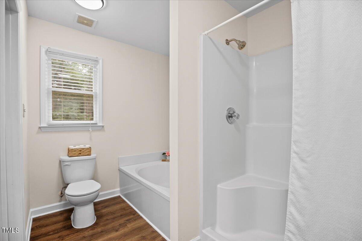 4309 Birmingham Way Raleigh, NC 27604 - Photo 37 of 60 a bathroom with a toilet and a shower