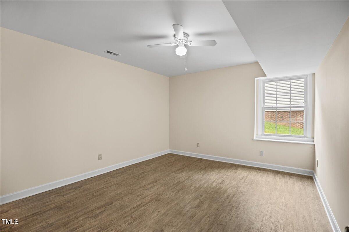 4309 Birmingham Way Raleigh, NC 27604 - Photo 49 of 60 an empty room with a window and wooden floor