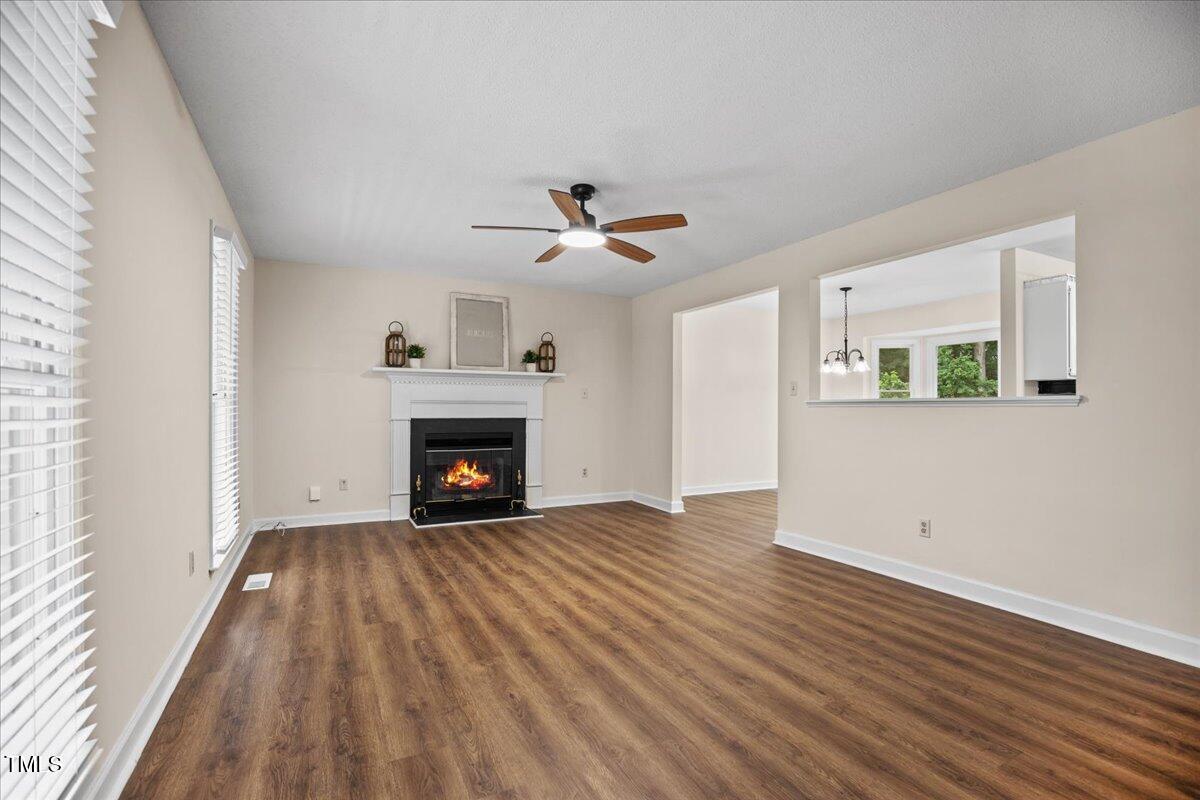 4309 Birmingham Way Raleigh, NC 27604 - Photo 8 of 60 wooden floor fireplace and windows in an empty room