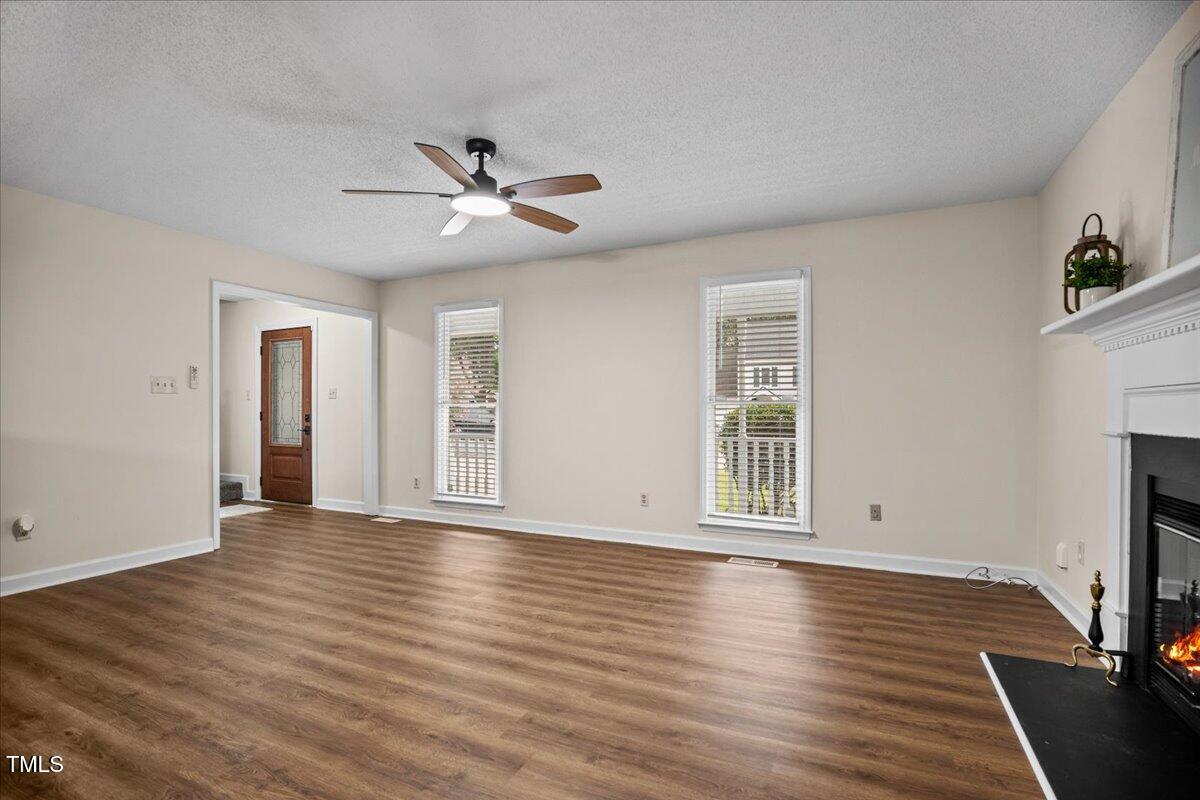4309 Birmingham Way Raleigh, NC 27604 - Photo 9 of 60 a view of an empty room with wooden floor and a window