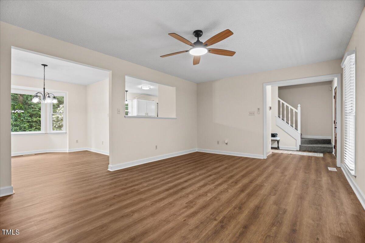 4309 Birmingham Way Raleigh, NC 27604 - Photo 10 of 60 a view of an empty room with wooden floor and a window