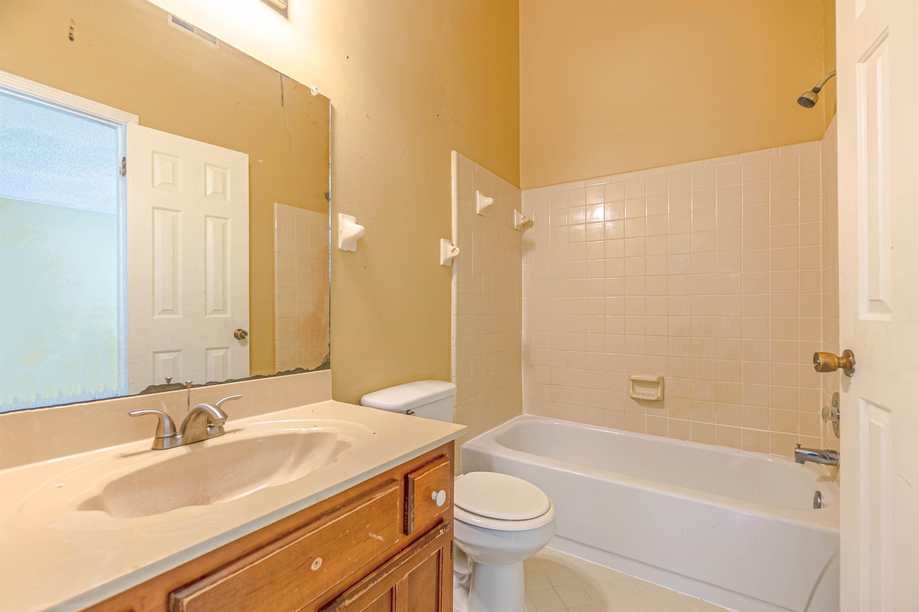 5891 Ridgehill Drive Memphis, TN 38141 - Photo 11 of 13 Full bathroom with vanity, tiled shower / bath combo, and toilet